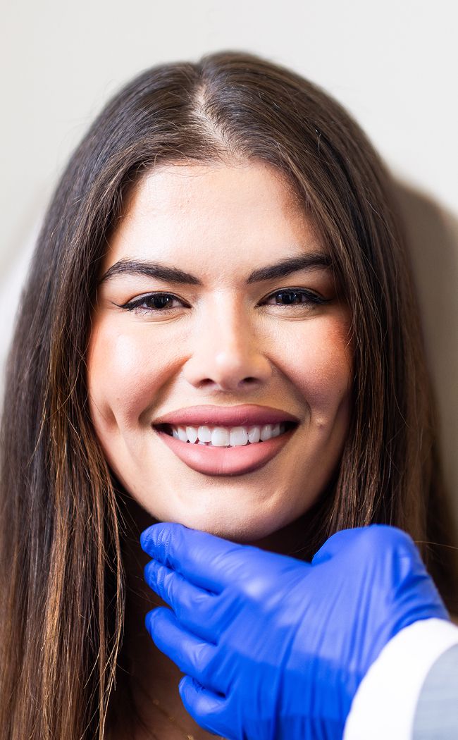 Smiling woman during a cosmetic consultation.