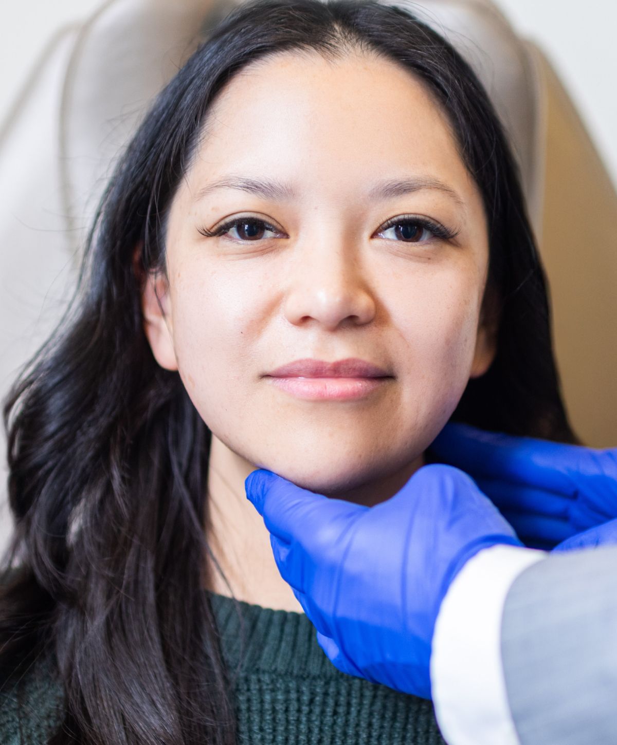 Person receiving facial treatment in a clinic.